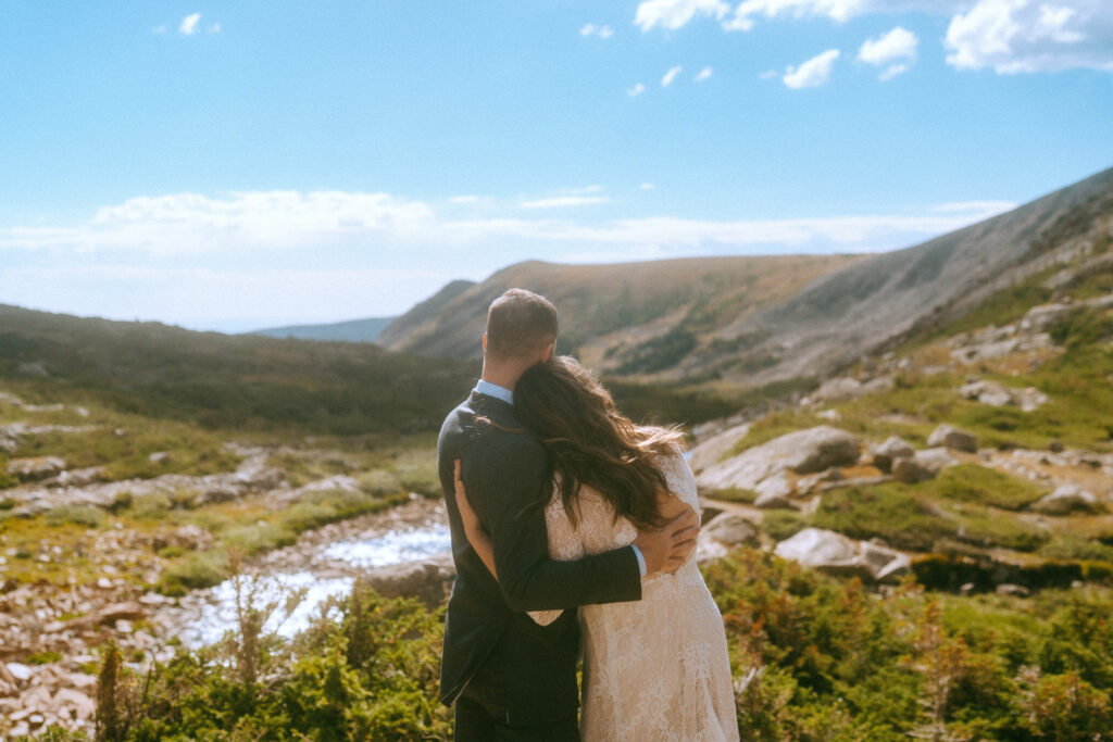 bride and groom take in scenery while hugging during their Colorado elopement