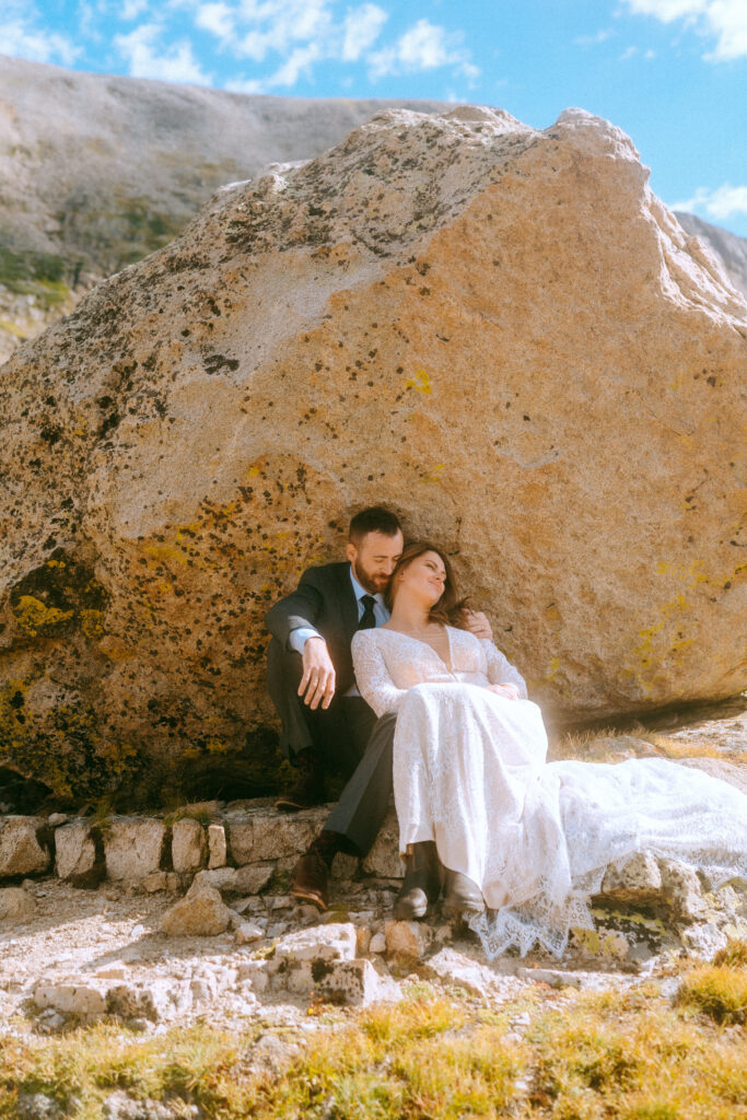 bride and groom snuggling on rock during their Colorado elopement