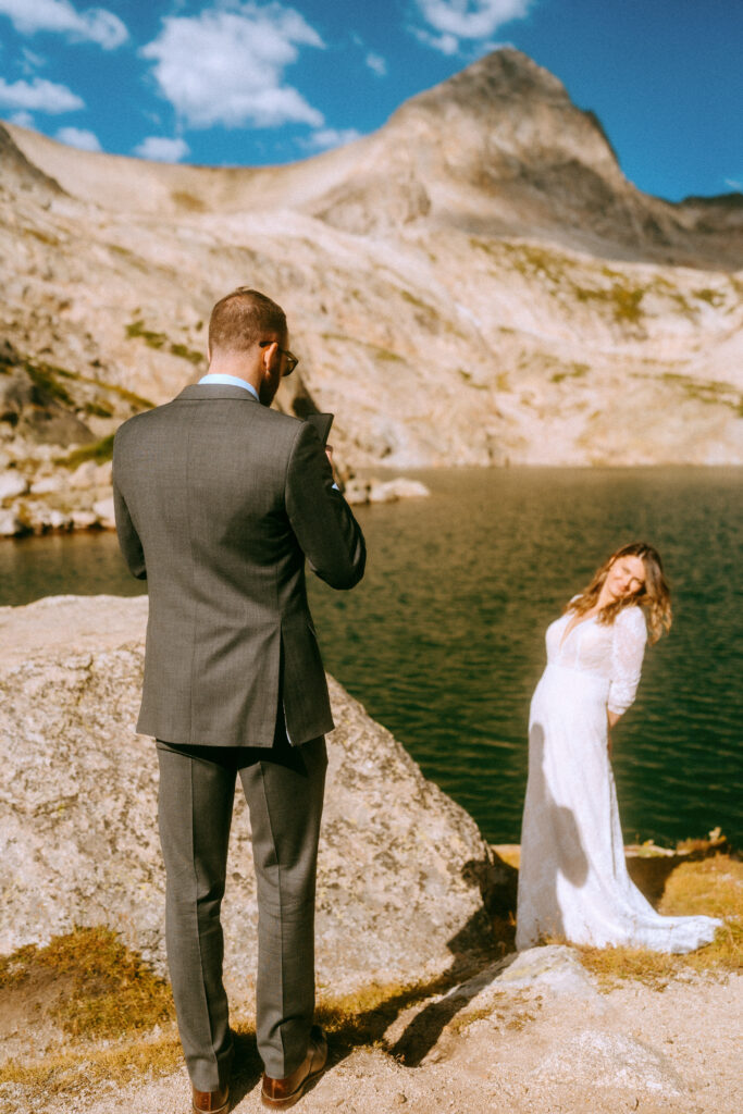 groom taking photo of bride during their Colorado elopement